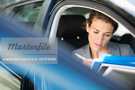 Businesswoman working in car