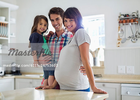 Family smiling together in kitchen