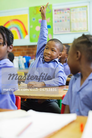 Student raising hand in class