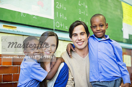 Teachers and students smiling in class