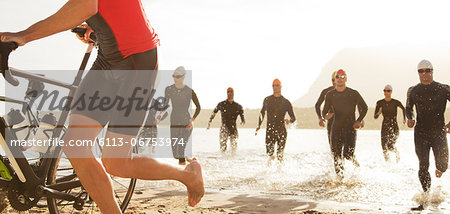 Triathletes emerging from water