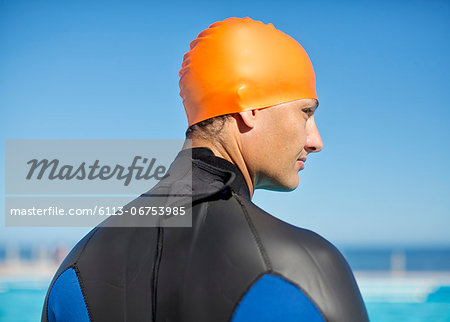 Triathlete wearing wetsuit and cap