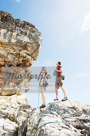 Climbers examining steep rock face