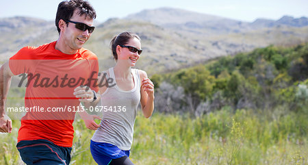 Couple running in rural landscape