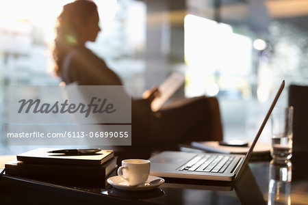 Businesswoman using digital tablet in lobby