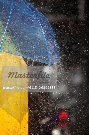 Close up of woman under umbrella in rain