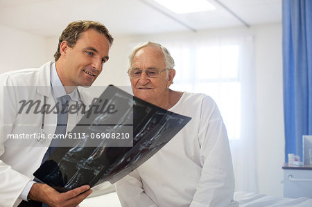 Doctor and patient examining x-rays in hospital room