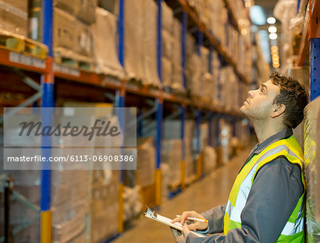Worker checking boxes in warehouse