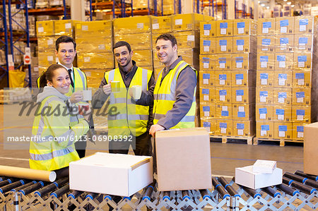 Workers drinking coffee in warehouse