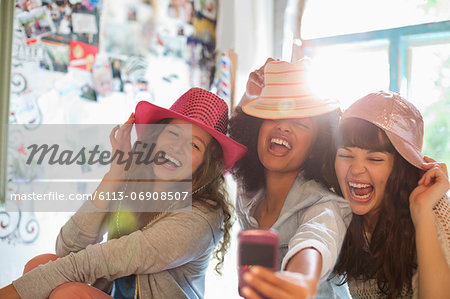 Women wearing hats in bedroom Women wearing hats in bedroom
