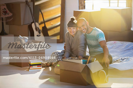 Couple unpacking boxes in attic