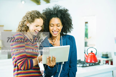 Women listening to earphones together