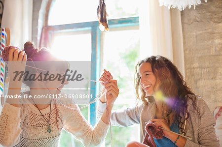 Women playing with yarn together