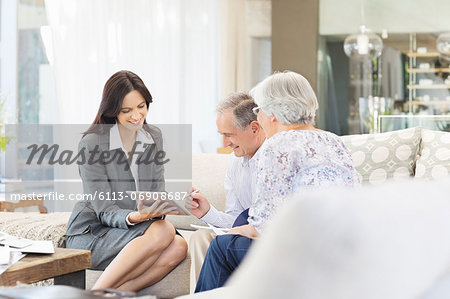 Financial advisor using tablet computer with clients