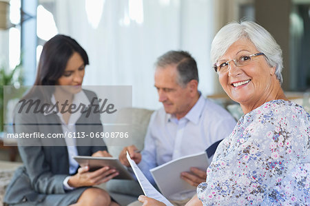 Financial advisor talking to couple on sofa