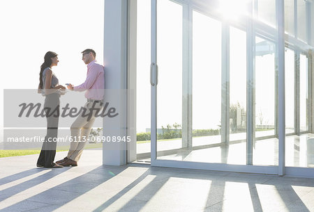 Business people talking outside office