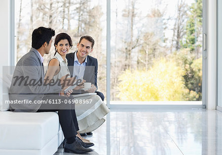 Business people talking on sofa in office