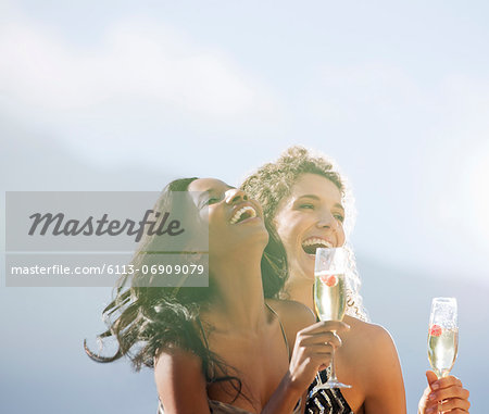 Women drinking champagne together outdoors