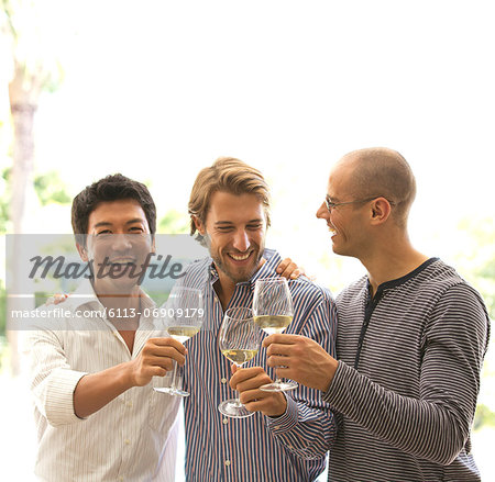 Men toasting each other with wine