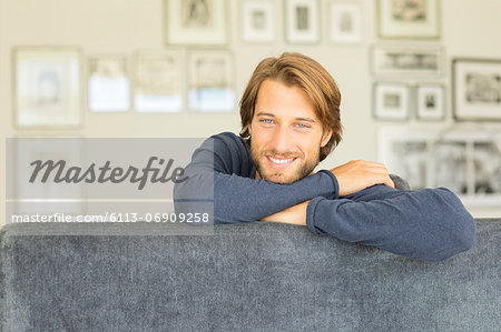 Smiling man sitting on sofa