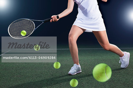 Multiple exposure of tennis player hitting ball on court