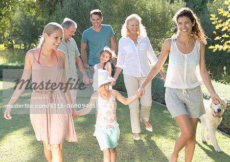 Family walking together in backyard Family walking together in backyard