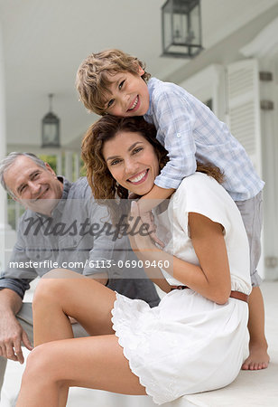 Mother and son smiling on porch