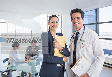 Portrait of smiling businesswoman and doctor in meeting