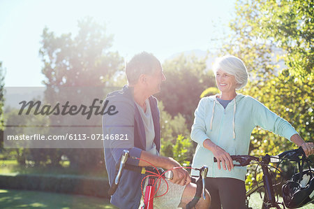 Senior couple with bicycles in park