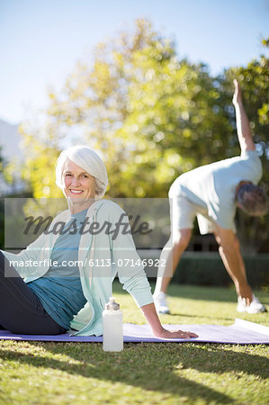 Senior couple exercising in park
