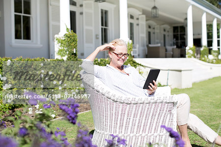 Senior woman using digital tablet in garden