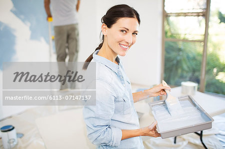 Couple painting wall blue