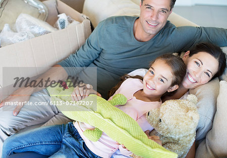 Portrait of smiling family with stuffed animals on sofa Portrait of smiling family with stuffed animals on sofa