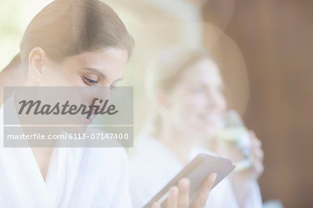 Woman using digital tablet at spa