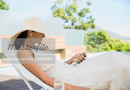 Woman listening to mp3 player outdoors