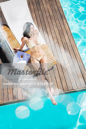 Woman relaxing poolside