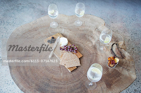 Fruit, cheese and wine on wood log table