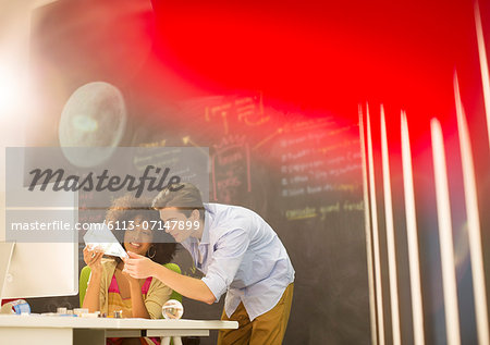 Business people examining model in office