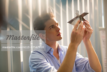 Businessman examining model in office