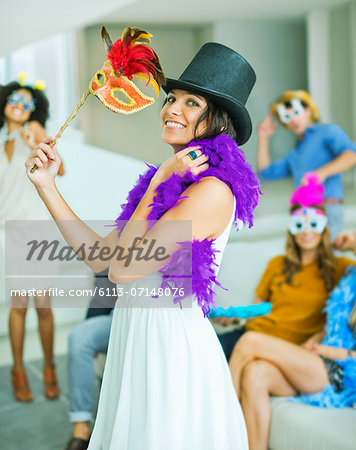 Woman wearing decorative hat with mask at party