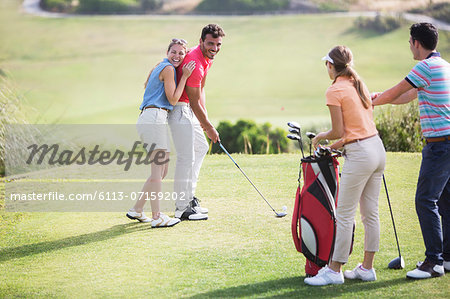 Friends laughing on golf course