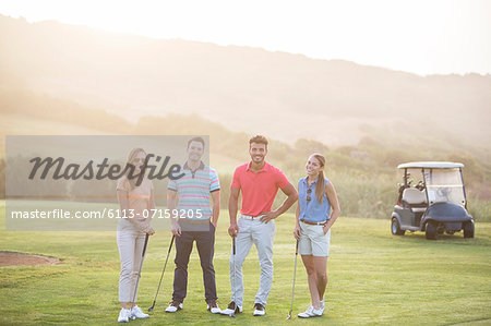 Friends smiling on golf course