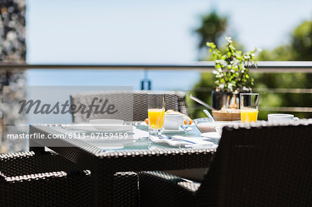 Breakfast on luxury patio dining table overlooking ocean