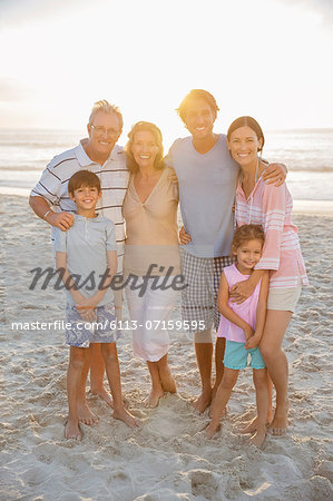 Family smiling together on beach