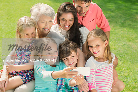 Family taking picture together with cell phone