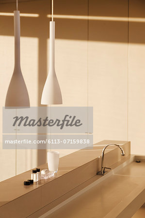 Sink and pendant light in modern bathroom