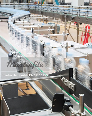 Bottles on conveyor belt in factory