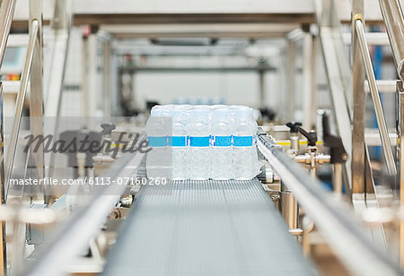 Water bottles on conveyor belt in factory Water bottles on conveyor belt in factory