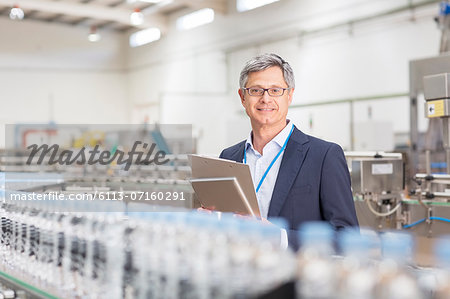 Supervisor smiling in bottling plant Supervisor smiling in bottling plant