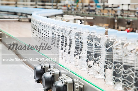 Bottles on conveyor belt in factory